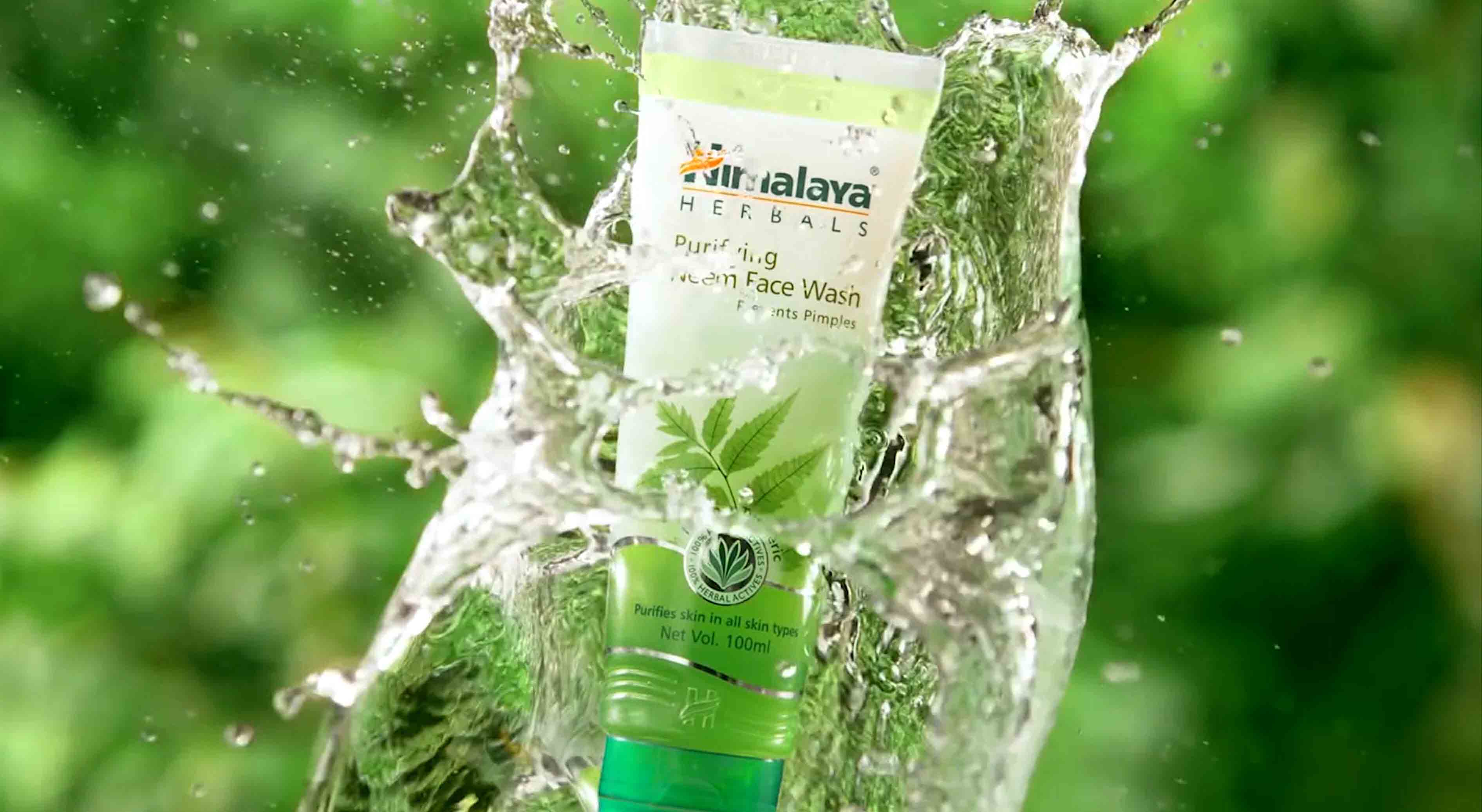 Himalaya face wash product splashing through water