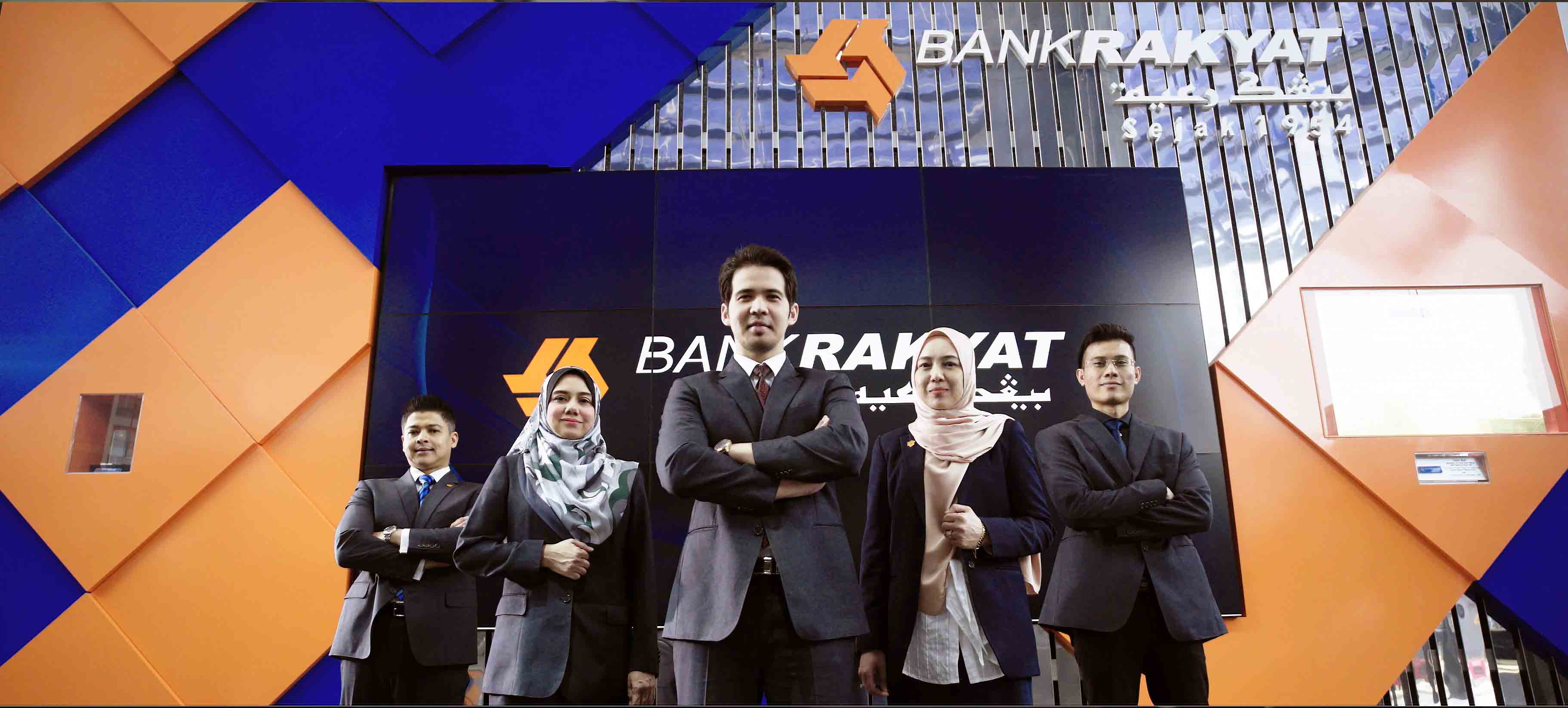 Bank Rakyat corporate team in front of headquarters branding