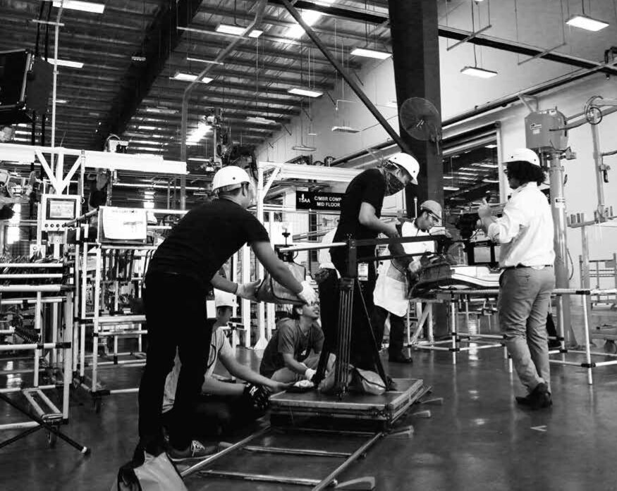 PurplePerfect production crew filming inside an industrial facility